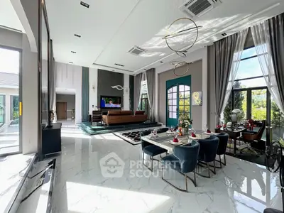 Luxurious open-plan living and dining area with high ceilings and elegant decor