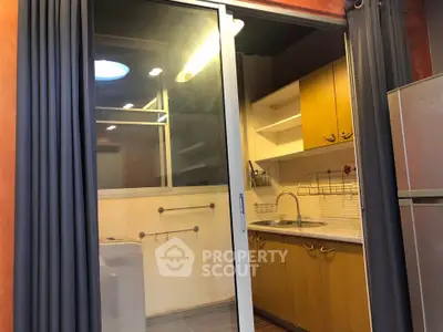 Cozy kitchen with sliding glass door and modern appliances