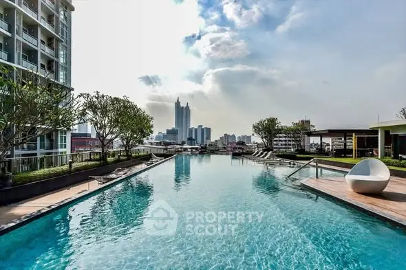Luxurious rooftop pool with stunning city skyline views in modern residential complex.