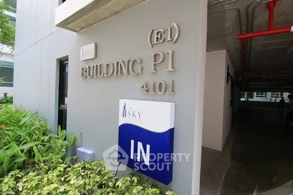 Entrance of Building P1 with clear signage and lush greenery
