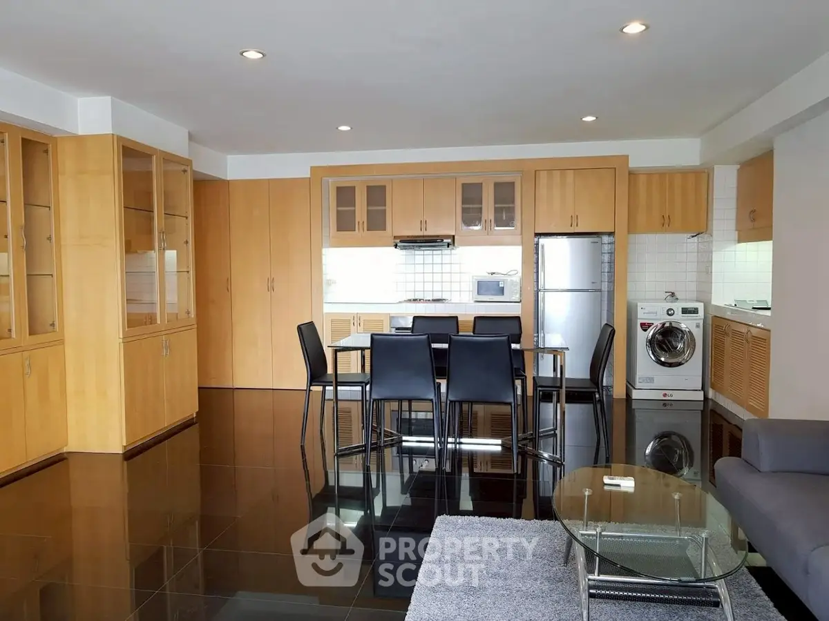 Spacious modern kitchen with dining area and sleek appliances in open layout