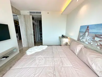 Luxurious bedroom with elegant decor and modern amenities, featuring a plush bed and stylish artwork.