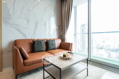 Modern living room with leather sofa and city view from large window