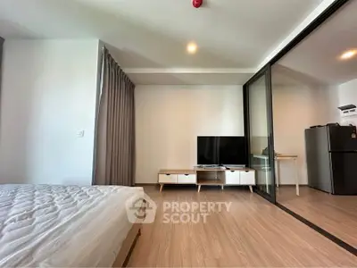 Modern studio apartment with sleek design and glass partition