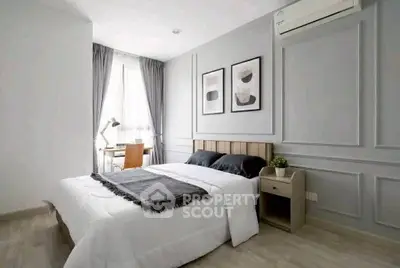 Modern bedroom with stylish decor and natural light, featuring a cozy bed and elegant wall art.