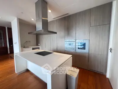 Modern kitchen with sleek cabinetry and island in luxury apartment