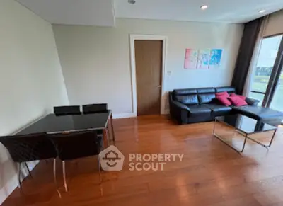Spacious living room with modern furniture and large window view