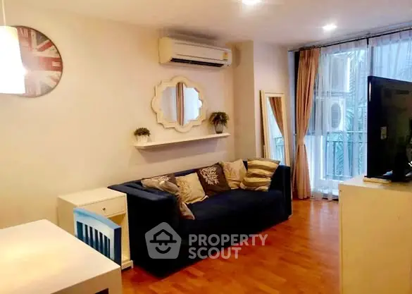 Cozy living room with modern decor and natural light, featuring a comfortable sofa and stylish wall art.