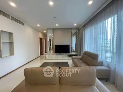 Spacious modern living room with large windows and elegant furniture
