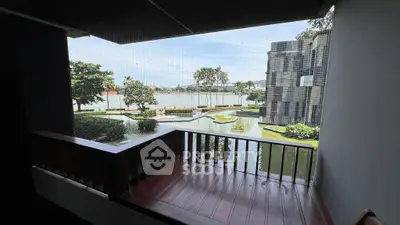 Stunning balcony view overlooking serene water garden in modern residential complex.