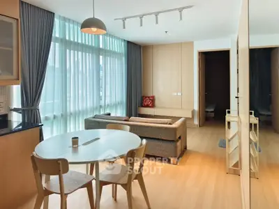 Modern living room with natural light and stylish furniture in a contemporary apartment.