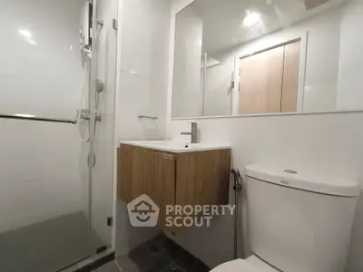 Modern bathroom with sleek fixtures and glass shower enclosure