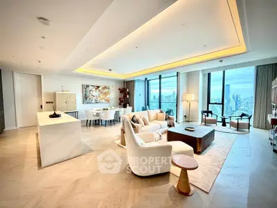 Luxurious open-plan living room with stunning city views and elegant modern decor.