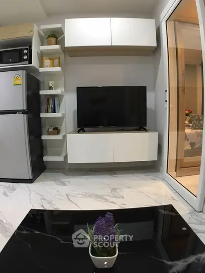 Modern living room with sleek TV setup and marble flooring