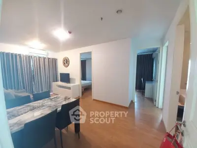 Spacious modern living room with dining area and bedroom view