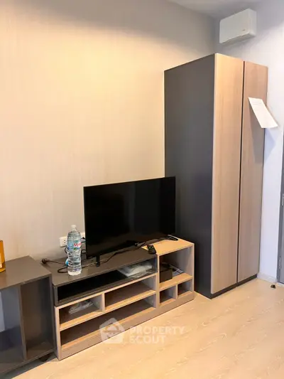 Modern living room with sleek TV stand and wardrobe, perfect for urban living.