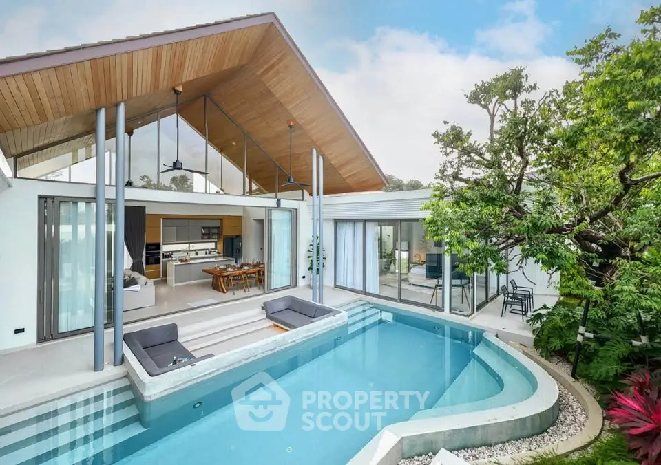 Luxurious modern villa with private pool and open-plan living area, featuring sleek architecture and lush greenery.