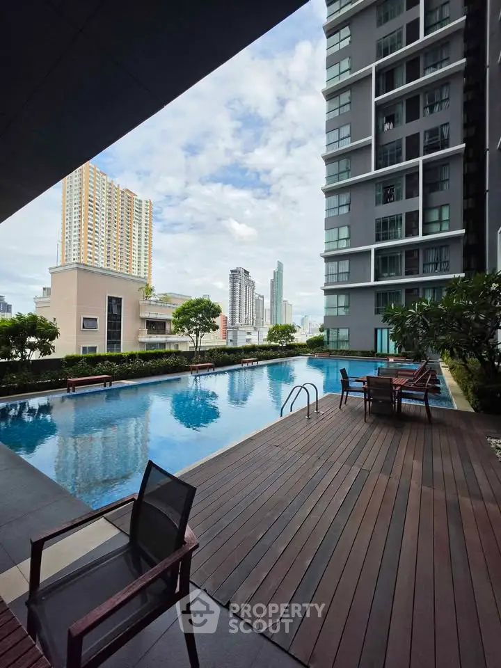 Luxurious high-rise building with stunning pool and city view, perfect for urban living.
