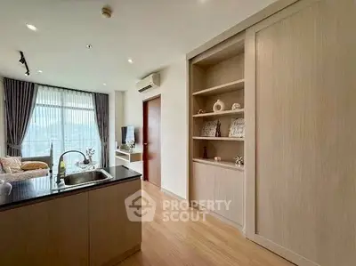 Modern open-plan living room with stylish kitchen and scenic window view