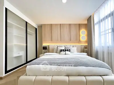 Luxurious modern bedroom with elegant decor and ample natural light
