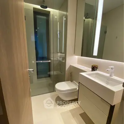 Modern bathroom with sleek fixtures and glass shower enclosure