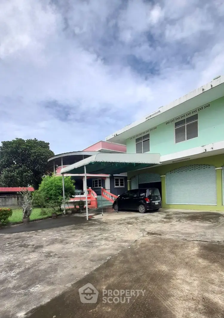 Spacious residential property with carport and lush greenery