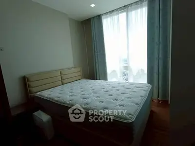 Cozy bedroom with large window and natural light