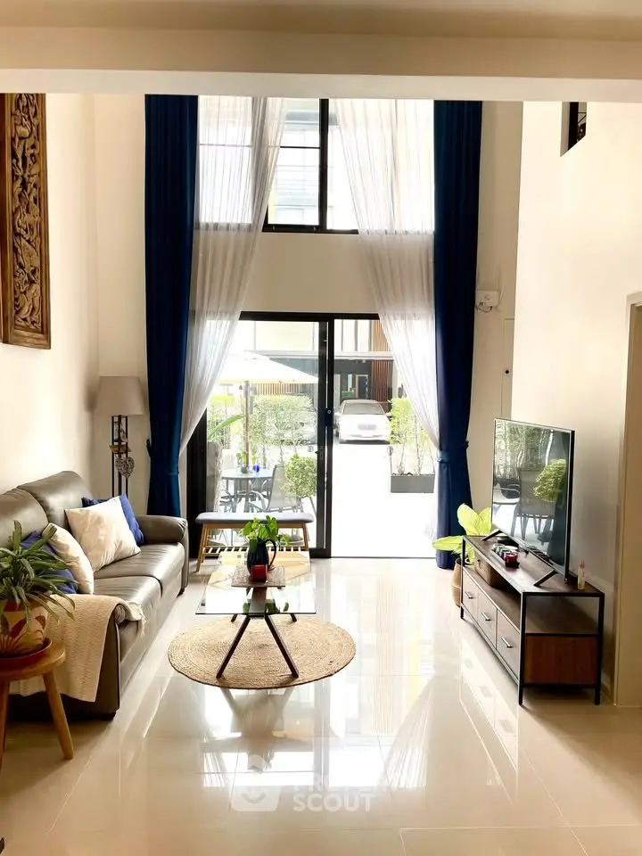 Spacious living room with high ceilings and modern decor