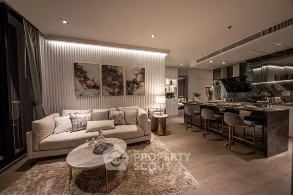 Luxurious open-plan living room with modern kitchen and elegant decor.