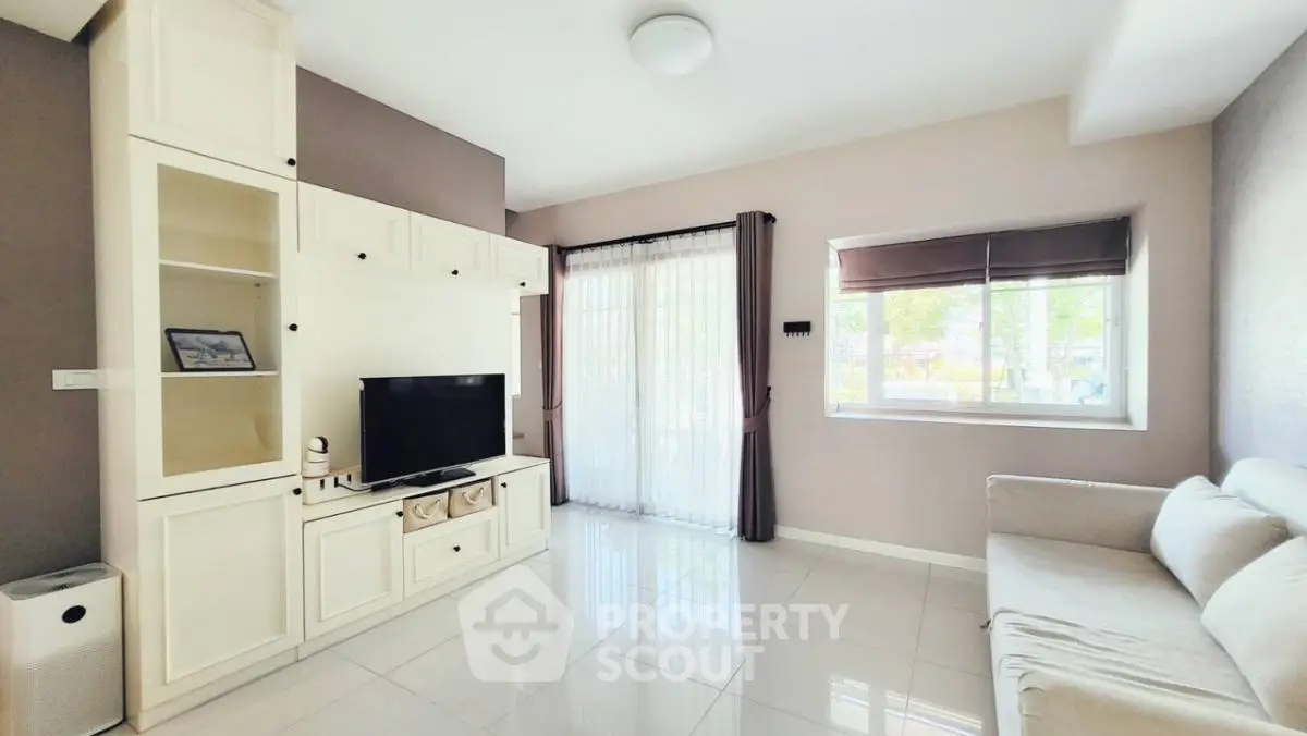 Bright and spacious living room with modern decor and large windows