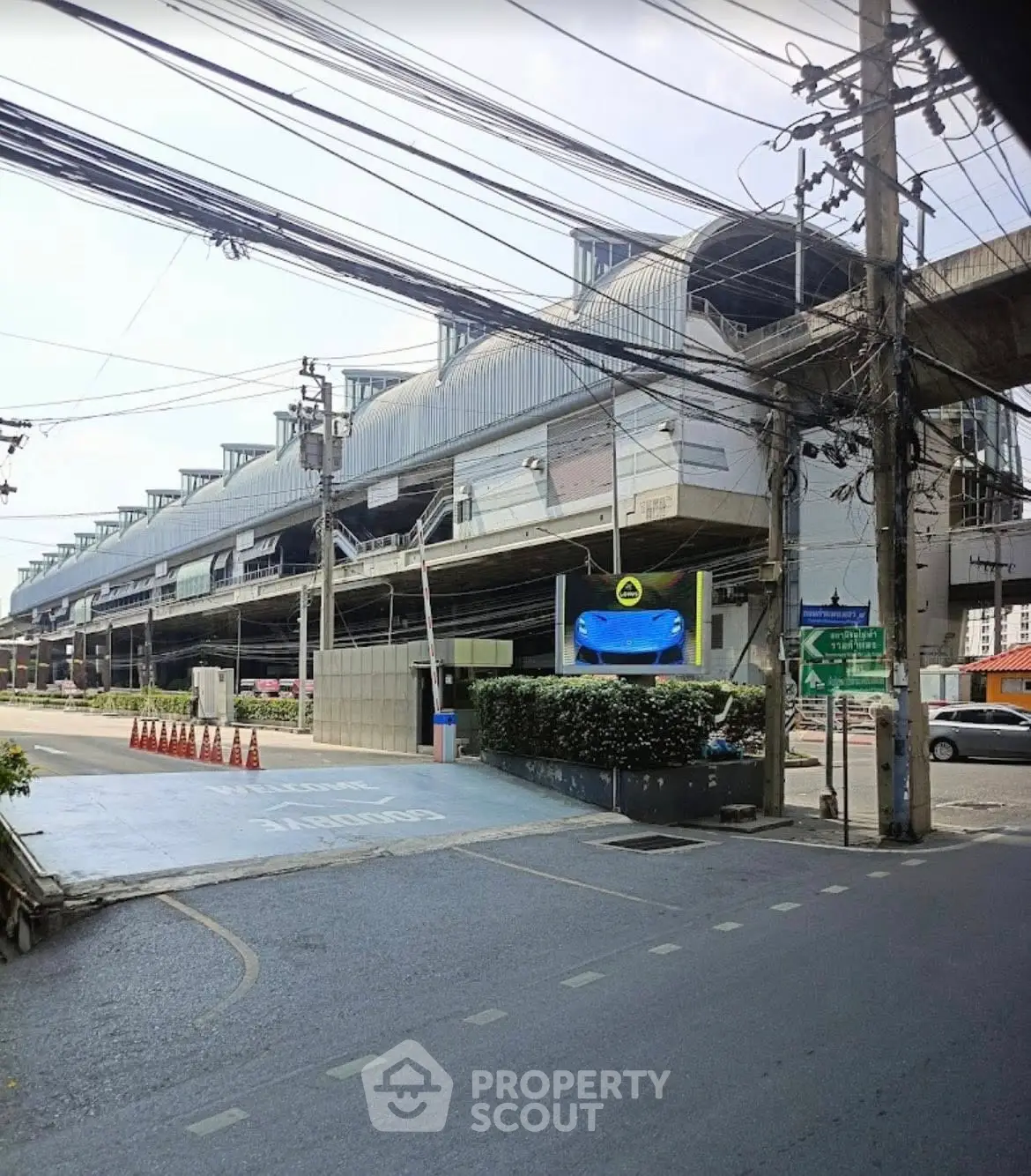 Modern urban building with unique architectural design and street view.