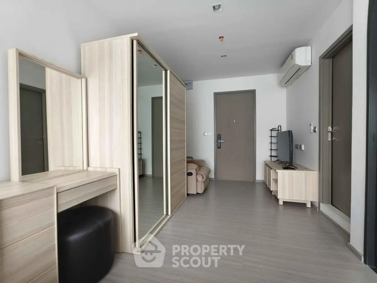 Modern apartment interior with sleek furniture and mirrored wardrobe