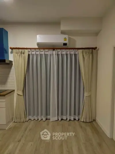 Modern kitchen corner with air conditioning and elegant curtains