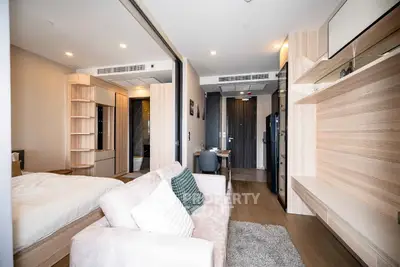 Modern studio apartment with open layout, cozy living area, and stylish decor.