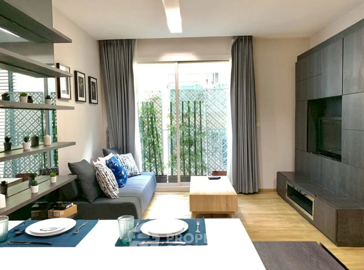 Modern living room with stylish decor and natural light, featuring a cozy sofa and elegant dining area.