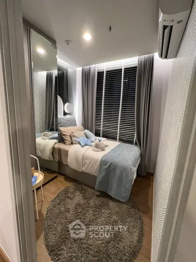 Cozy modern bedroom with stylish decor and large window