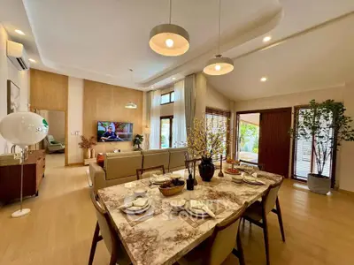 Luxurious open-plan living room with elegant dining area and modern decor
