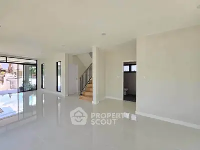 Spacious modern living room with glossy tile flooring and large windows