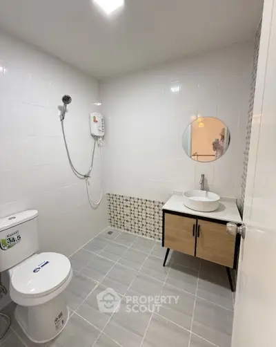 Modern bathroom with sleek fixtures and stylish vanity in a contemporary home.