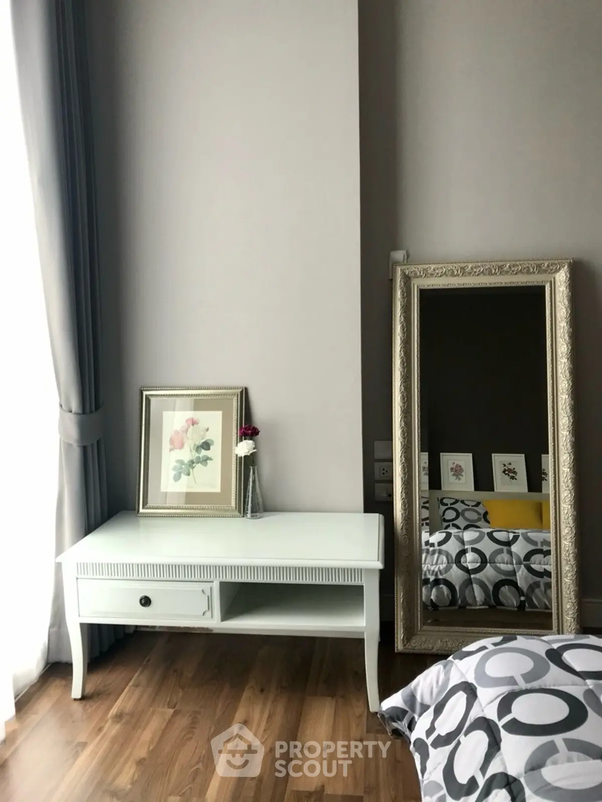 Chic bedroom corner with elegant decor and full-length mirror