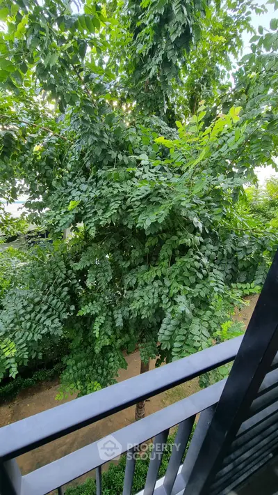 Lush garden view from a modern balcony, perfect for nature lovers.
