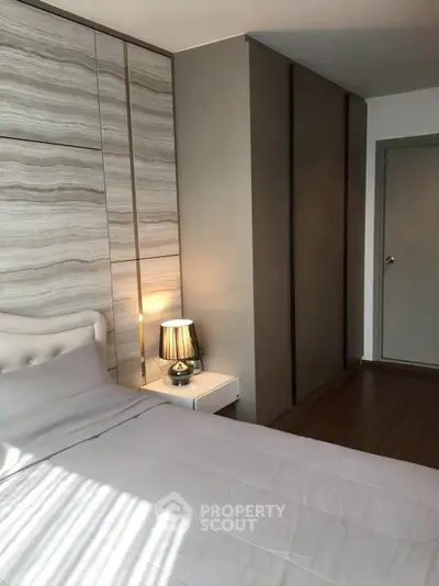 Modern bedroom with stylish decor and ample natural light