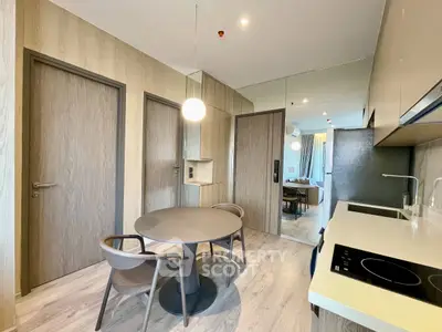 Modern kitchen with sleek design, open layout, and stylish dining area in contemporary apartment.
