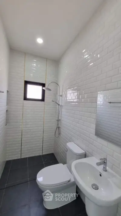 Modern bathroom with sleek white tiles and contemporary fixtures