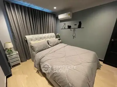 Cozy bedroom with stylish decor and modern air conditioning unit, perfect for relaxation.