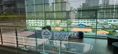 Modern balcony with glass railing and city view, perfect for relaxation and entertainment.