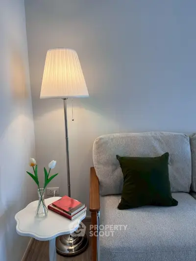Cozy living room corner with elegant floor lamp and plush sofa