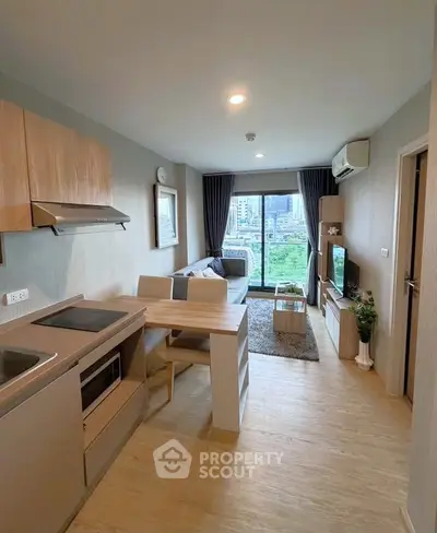 Modern open-plan living room with kitchen and city view balcony