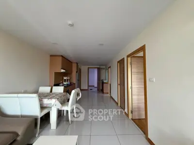 Spacious open-plan living and dining area with modern furnishings and tiled flooring.