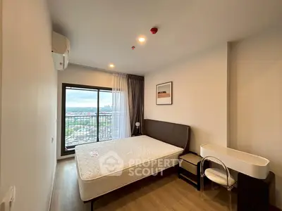 Modern bedroom with large window offering city view and minimalist decor.